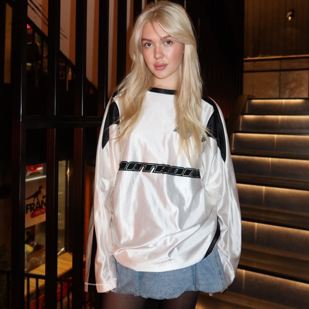 Veronika Mochalova in white DATRON sweatshirt and denim skirt