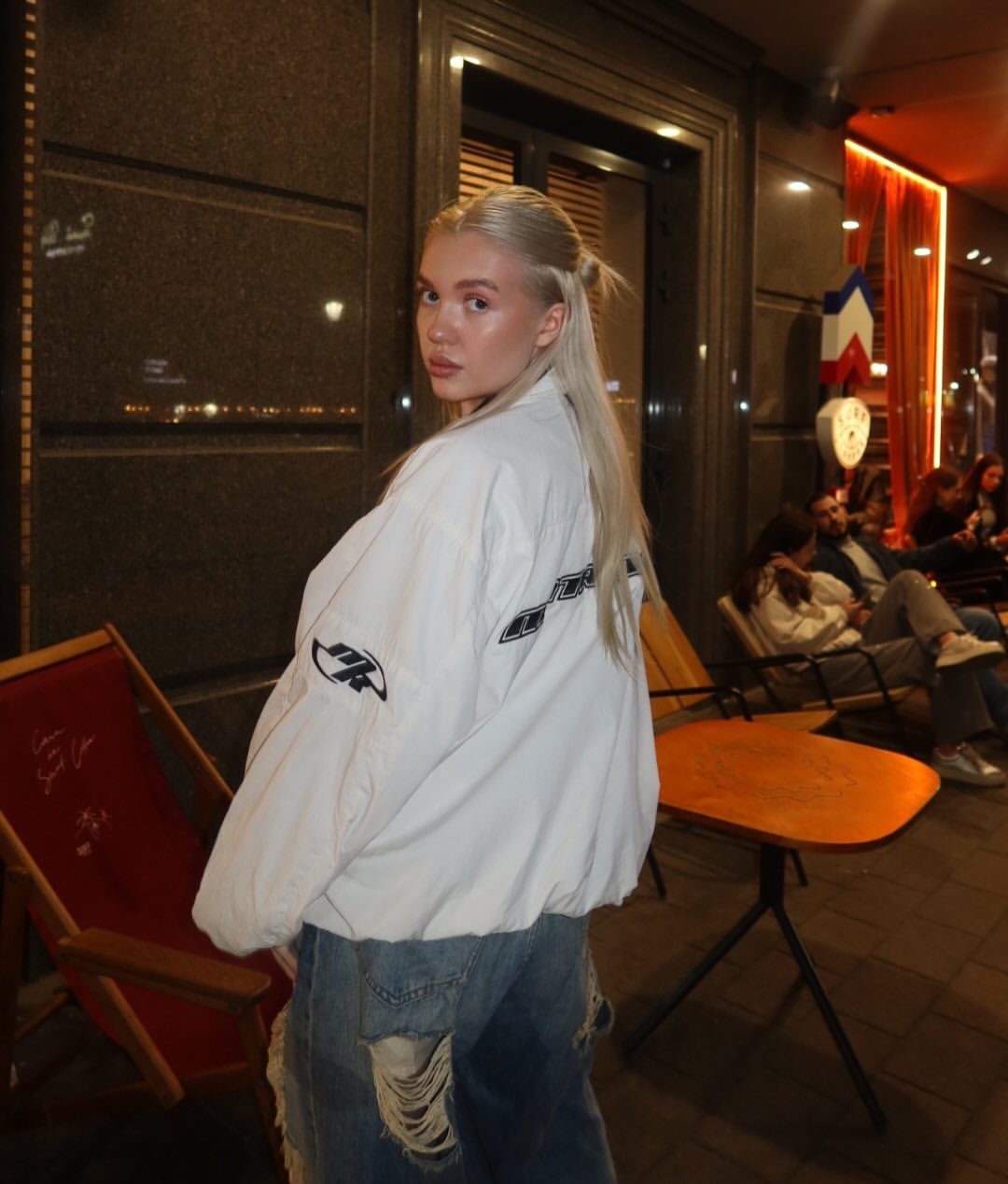 Veronika Mochalova in white bomber jacket and ripped jeans